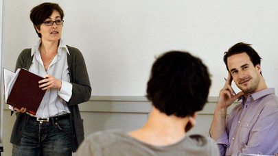 Three people talking in a workshop