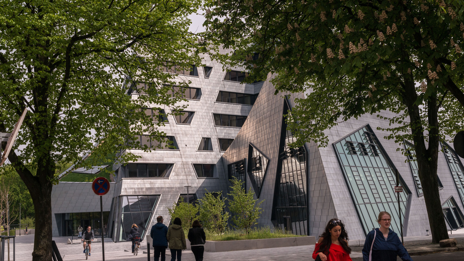 Exterior view of the central building. View of the central building with people walking towards and away from it.
