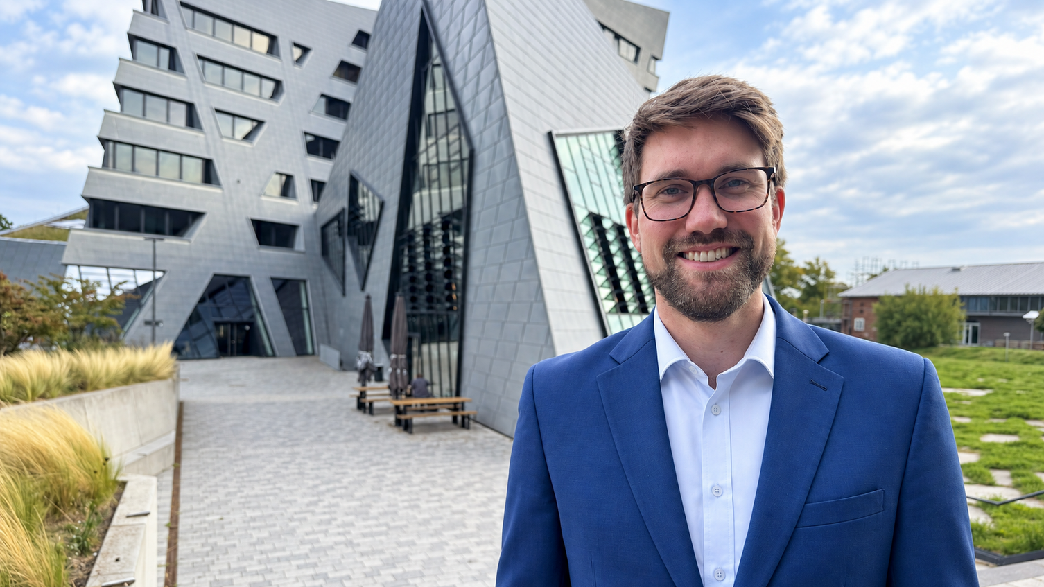 Professor Florian Stamer in front of the main building at Leuphana university