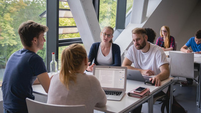 Students working as a group in a seminar room.