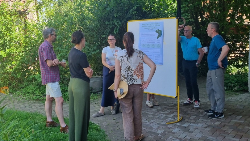 Participants of the retreat discuss during the poster session