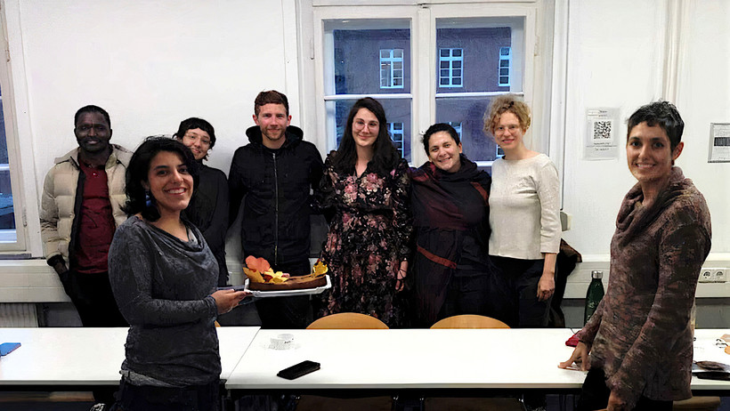 Group photo of the ISDP team in a seminar room at Leuphana University