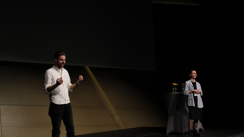 Marcel Schröder und Alina Thiemann moderieren die letzte Veranstaltung der Konferenzwoche. Mit den Worten „Ihr habt es geschafft! Ihr habt das berüchtigte Leuphana Semester hinter euch gebracht“, fordert Marcel die Erstsemester zu einem kräftigen Applaus für sich selbst auf.